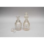 A pair of 19th century engraved decanters, once part of a larger suite, one stopper broken and