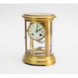 A 20th century oval brass four glass clock