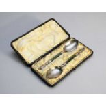 A cased pair of silver spoons with jade handles