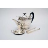 A silver teapot, pair of sugar tongs and taperstick
