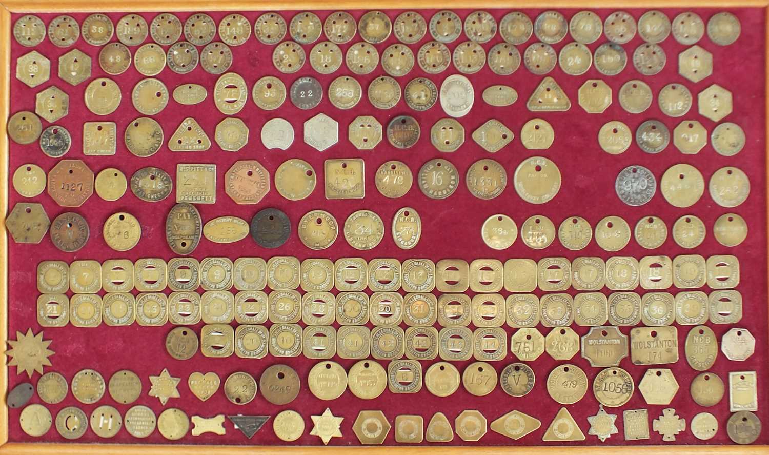 A collection of brass and white metal colliery and associated tokens and checks