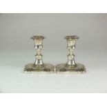 A pair of early 20th century silver mounted short candlesticks