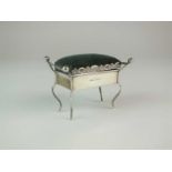 An Edwardian novelty silver pin cushion in the form of a piano stool