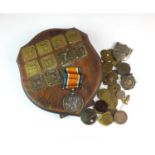 A small collection of brass tokens, fobs and badges