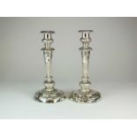 A near pair of George III silver candlesticks
