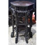 A 19TH CENTURY CHINESE CARVED HONGMU HARDWOOD HEXAGONAL TABLE Qing, decorated with foliage and vines