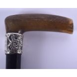 A 19TH CENTURY CONTINENTAL CARVED RHINOCEROS HORN HANDLED WALKING CANE with silver mounts. 87 cm lon
