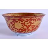 A 19TH CENTURY JAPANESE MEIJI PERIOD KUTANI PORCELAIN BOWL painted upon a coral ground with dragons.