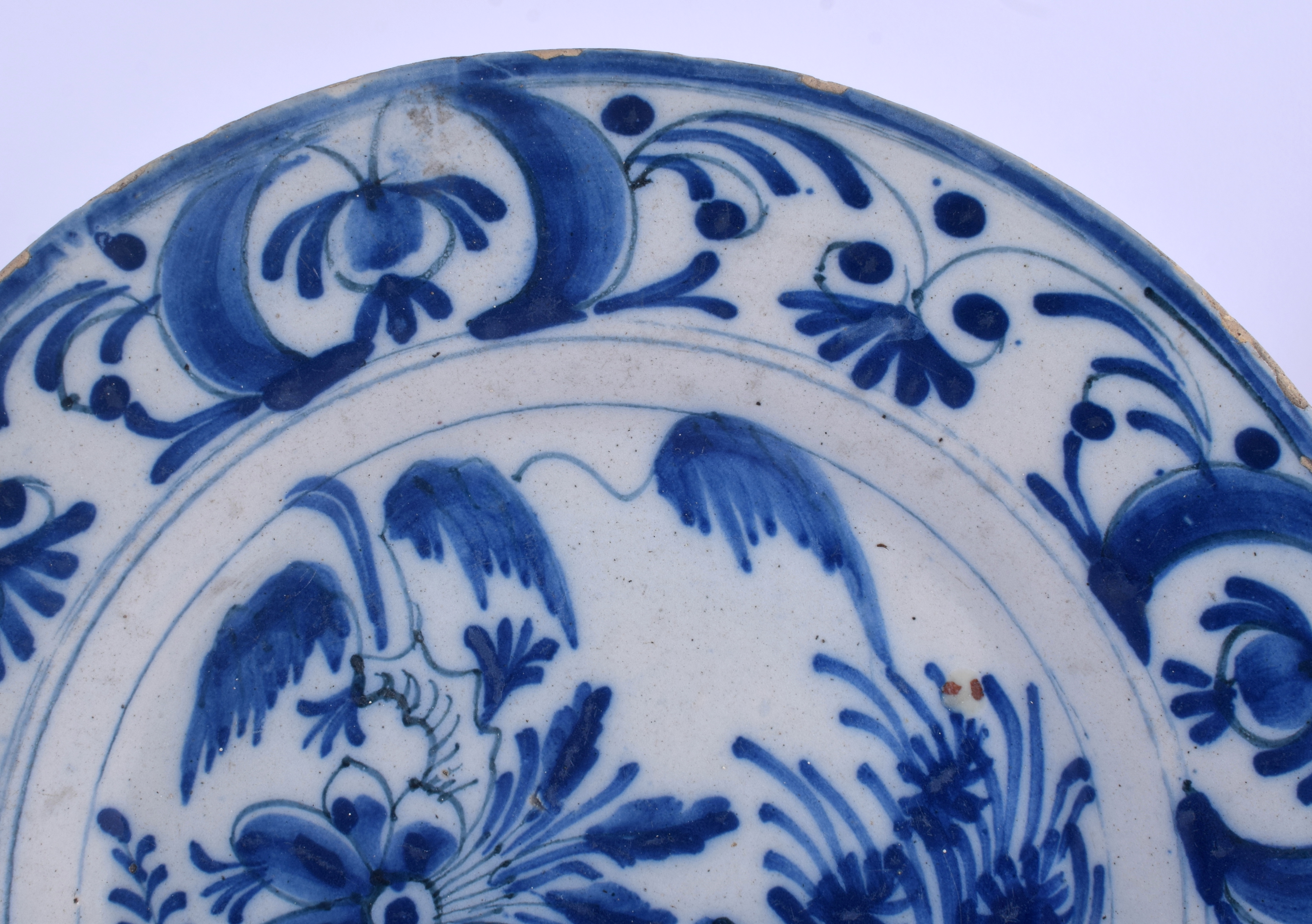 TWO 18TH CENTURY DUTCH DELFT BLUE AND WHITE POTTERY PLATES painted with flowers and motifs. 22 cm di - Image 2 of 6