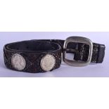 AN EARLY 20TH CENTURY CONTINENTAL LEATHER BELT set with eight 18th century Austrian thaler coins. 12