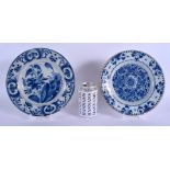 TWO 18TH CENTURY DUTCH DELFT BLUE AND WHITE POTTERY PLATES painted with flowers and motifs. 22 cm di