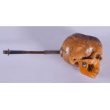 A RARE 19TH CENTURY CARVED MEERSCHAUM AND AMBER PIPE formed as an inscribed skull. 12.5 cm wide.