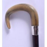 A 19TH CENTURY CONTINENTAL CARVED RHINOCEROS HORN WALKING CANE with silver mounts. 88 cm long.