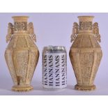 A PAIR OF 19TH CENTURY CHINESE TWIN HANDLED IVORY VASES Qing, decorated with figures in various purs