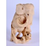 A 19TH CENTURY JAPANESE MEIJI PERIOD CARVED IVORY OKIMONO modelled as an elephant trampling upon a f