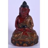 AN 18TH CENTURY SOUTH EAST ASIAN PAINTED LACQUER POTTERY BUDDHA modelled holding a censer upon a lot