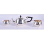 A STYLISH ART DECO SILVER THREE PIECE TEASET in the manner of Liberty & Co. Birmingham 1930. 745 gra