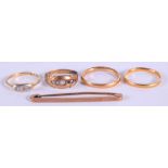 FOUR VINTAGE 9CT & 18CT GOLD RINGS and a 9ct gold brooch. 11 grams. (5)