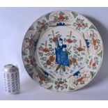 A LARGE EARLY 18TH CENTURY DUTCH DELFT FAIENCE TIN GLAZED DISH painted with a female in blue holding