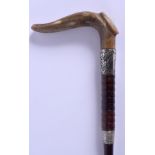 A 19TH CENTURY CONTINENTAL CARVED RHINOCEROS HORN WALKING CANE with silver mounts. 88 cm long.