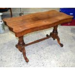 A VICTORIAN ROSEWOOD SOFA TABLE with scrolling supports. 137 cm x 68 cm x 74 cm.