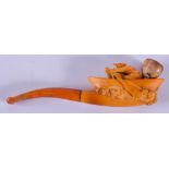 A 19TH CENTURY CARVED MEERSCHAUM AND AMBER PIPE formed as a man rowing upon his boat. 13.5 cm wide.