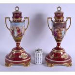 A LARGE PAIR OF EARLY 20TH CENTURY VIENNA TWIN HANDLED PORCELAIN VASES AND COVERS painted with figur