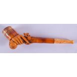 A RARE 19TH CENTURY CARVED MEERSCHAUM AND AMBER PIPE formed as a hand holding a musket. 13 cm wide.