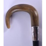 A 19TH CENTURY CONTINENTAL CARVED RHINOCEROS HORN WALKING CANE with silver mounts. 88 cm long.