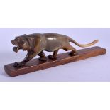 A 19TH CENTURY MIDDLE EASTERN CARVED RHINOCEROS HORN FIGURE OF A TIGER modelled roaming. 20 cm wide.