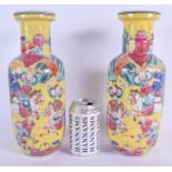 A RARE PAIR OF 19TH CENTURY CHINESE FAMILLE JAUNE ROULEAU VASES Qing, enamelled with figures on hors