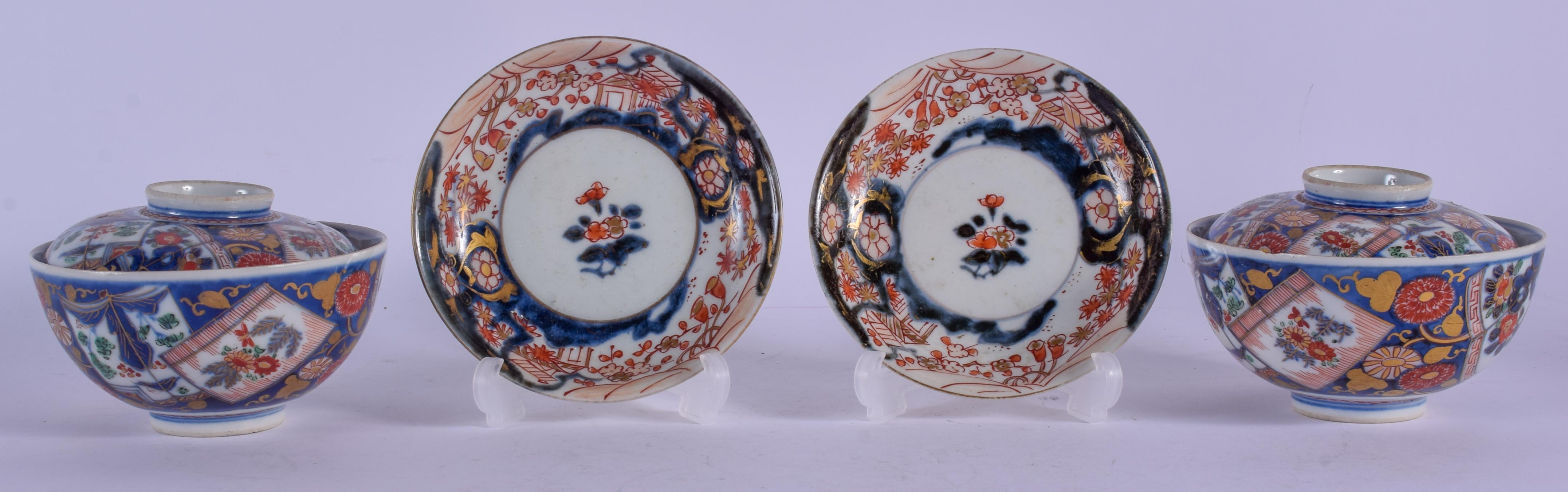A PAIR OF 19TH CENTURY JAPANESE MEIJI PERIOD IMARI BOWLS AND COVERS painted with floral sprays. 10 c