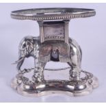 A RARE 19TH CENTURY CONTINENTAL SILVER MODEL OF A ROAMING ELEPHANT modelled upon a shaped base, embe