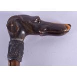A 19TH CENTURY CARVED RHINOCEROS HORN HANDLED WALKING CANE with white metal mounts. 85 cm long.