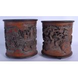 A PAIR OF CHINESE CARVED BAMBOO BRUSH POTS 20th Century, carved with scholars within landscapes. 17