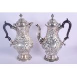 A MATCHED PAIR OF EDWARDIAN SILVER COFFEE POTS. London 1904 & 1905. 1770 grams. 29 cm high.