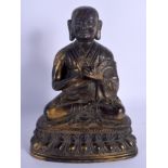 A CHINESE TIBETAN QING DYNASTY BRONZE FIGURE OF A BUDDHA modelled upon a lotus capped base. 21 cm x