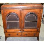 An carved oak two drawer bevelled glass fronted display cabinet 111 x 117cm.