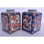 A PAIR OF 18TH CENTURY JAPANESE EDO PERIOD IMARI CANISTERS painted with floral sprays. 18 cm x 10 cm