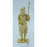 A small Japanese Meiji Period Ivory figure of a fisherman 20cm .