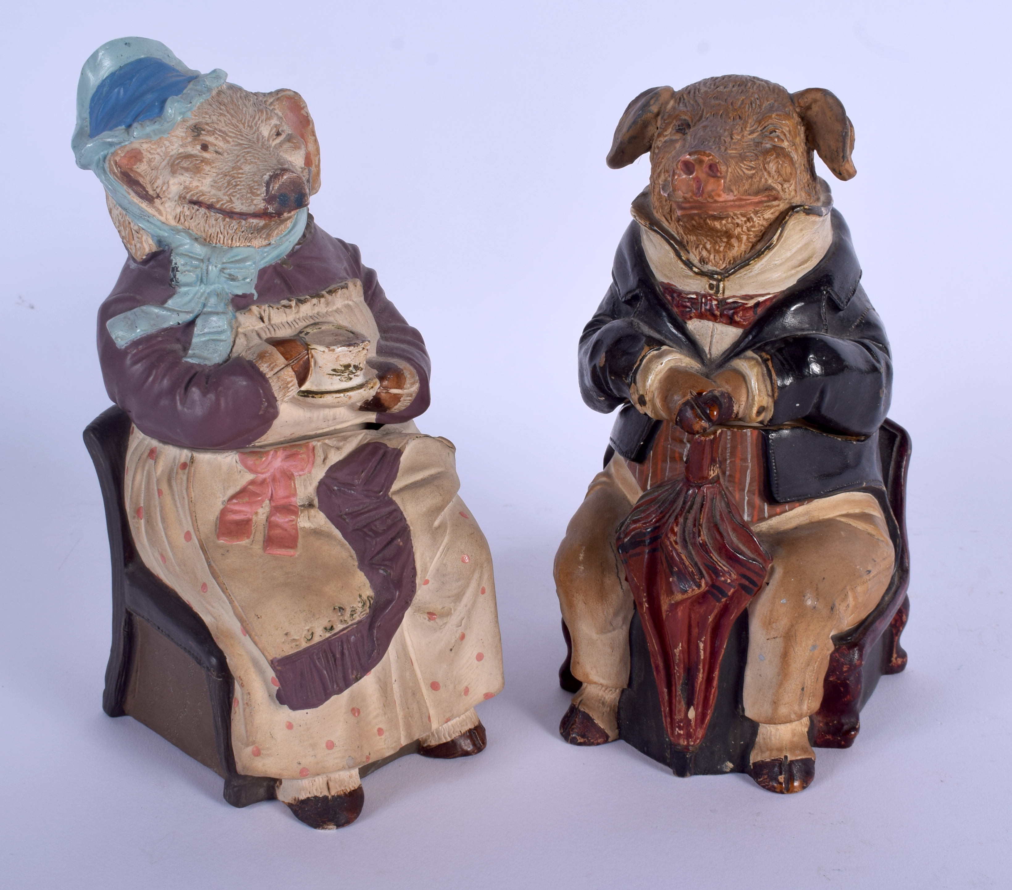 A PAIR ANTIQUE AUSTRIAN TOBACCO JAR AND COVER in the form of a pig and wolf. 17 cm high.