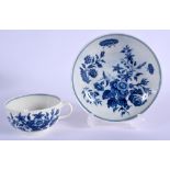 A 18TH C. WORCESTER HANDLED TEABOWL AND SAUCER decorated with blue flowers, script ‘W’ mark. Saucer