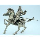 A white metal Guangon rider on a horse 18 x 23 cm.