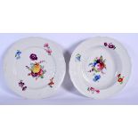 TWO 18TH CENTURY CONTINENTAL PORCELAIN PLATES painted with flowers under a wrythen moulded border. 2