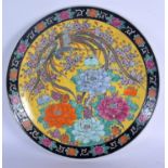 A JAPANESE TAISHO PERIOD FAMILLE JAUNE PORCELAIN DISH painted with birds and foliage. 30 cm diameter