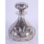 AN ART NOUVEAU SILVER OVERLAID SCENT BOTTLE AND STOPPER overlaid with flowers. 12 cm x 9 cm.