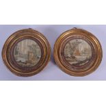 A PAIR OF 18TH CENTURY FRAMED EMBROIDERED SILK MINIATURES depicting landscapes. Silk 8 cm diameter.