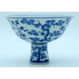 A Chinese blue and white Stem cup decorated with Plum, orchids and flowers 16 x 11cm