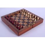 AN ANTIQUE CARVED AND STAINED BONE TRAVELLING CHESS SET. Largest 2.5 cm high. (qty)
