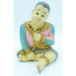 A decorated wooden figure of an Asian Boy 31 x 22cm.